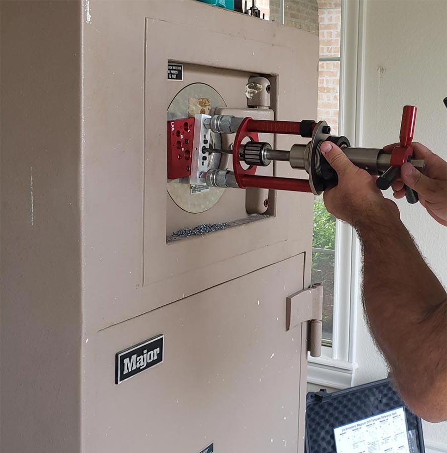 Locksmith drilling a safe to get it unlocked